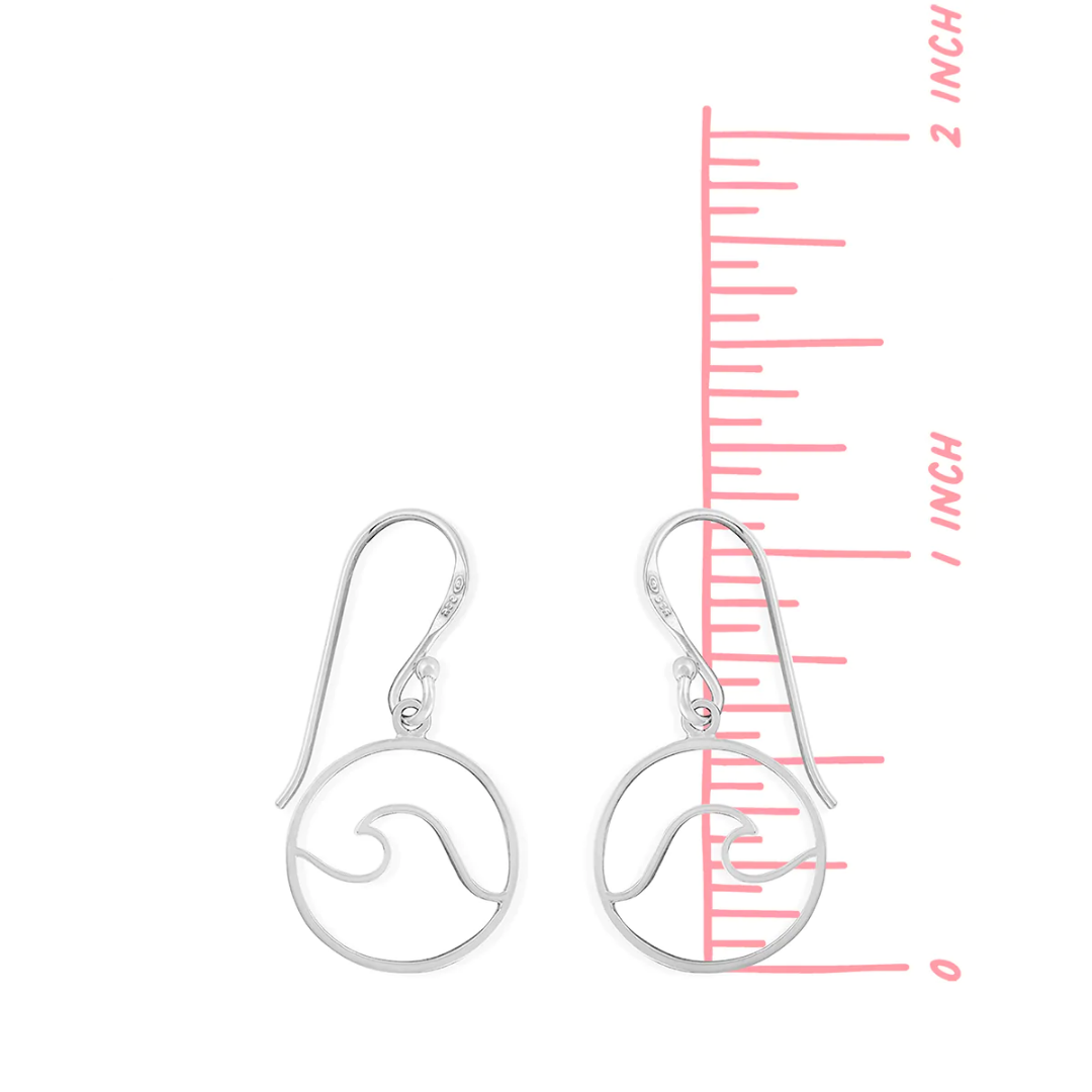 Presenting the boma Sterling Wire Wave Earrings: a pair of stylish, 1" long silver wire earrings featuring an elegant wave design. For scale, they are pictured next to a pink ruler and measure just under 2 inches in length.