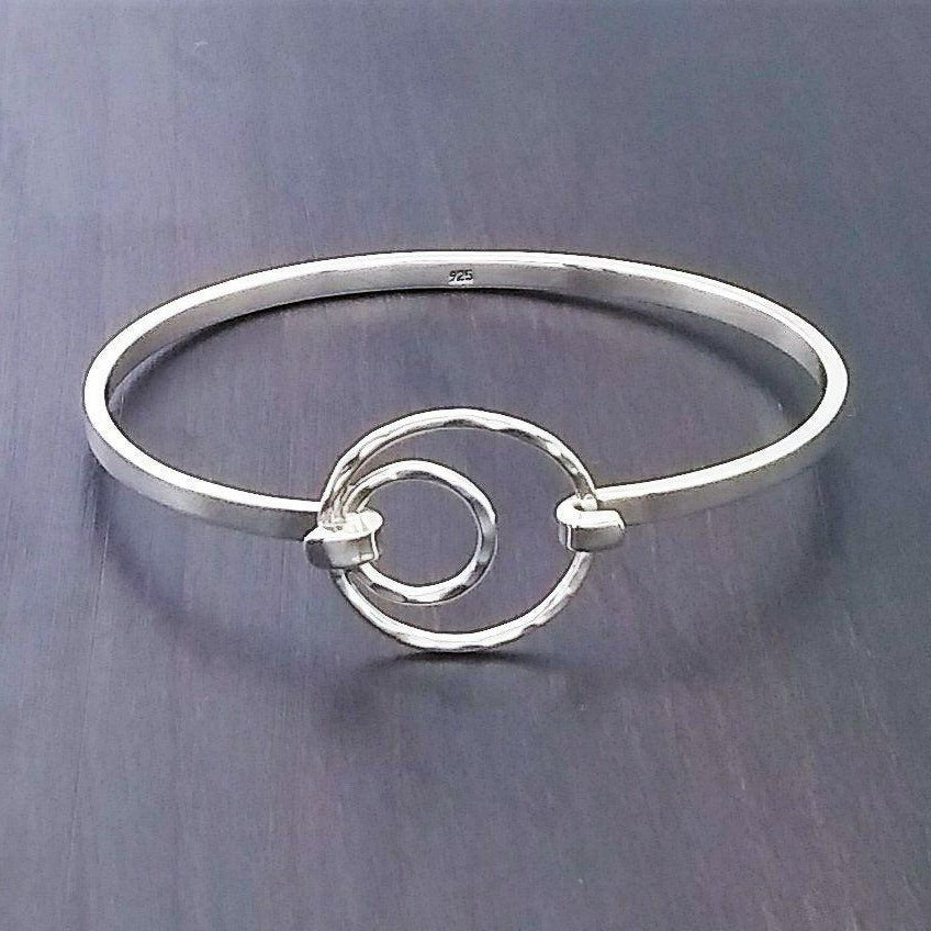 Via Taxco Clasp Bangle - slim band with a hammered circle and an offset smaller hammered circle inside that which holds the clasp.