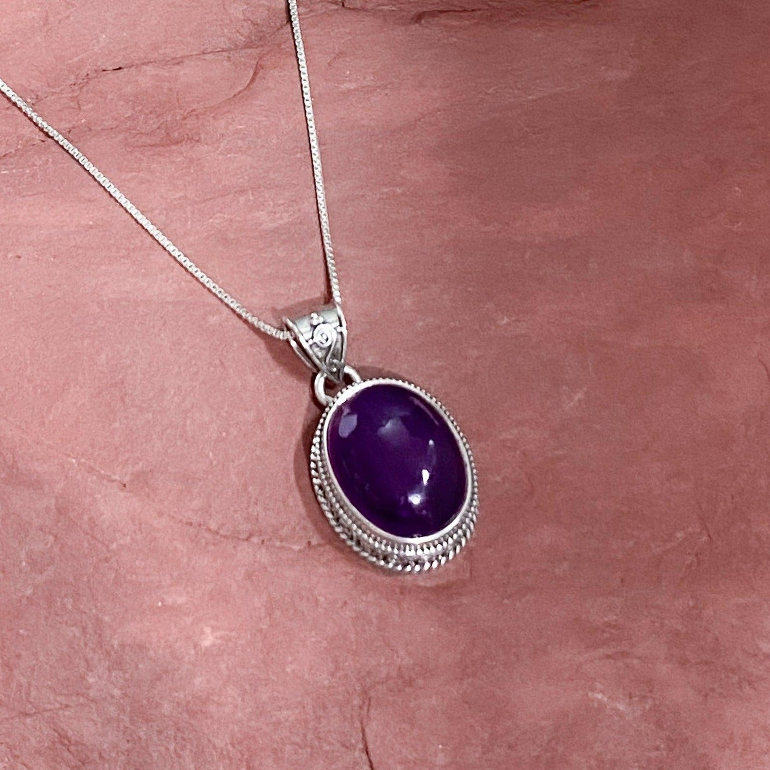 Amethyst Pendant In A Heavy Ornate setting . Dark purple. Cabachon stone. Urbansterlingsilver.com - Silver Parrot, Inc. 