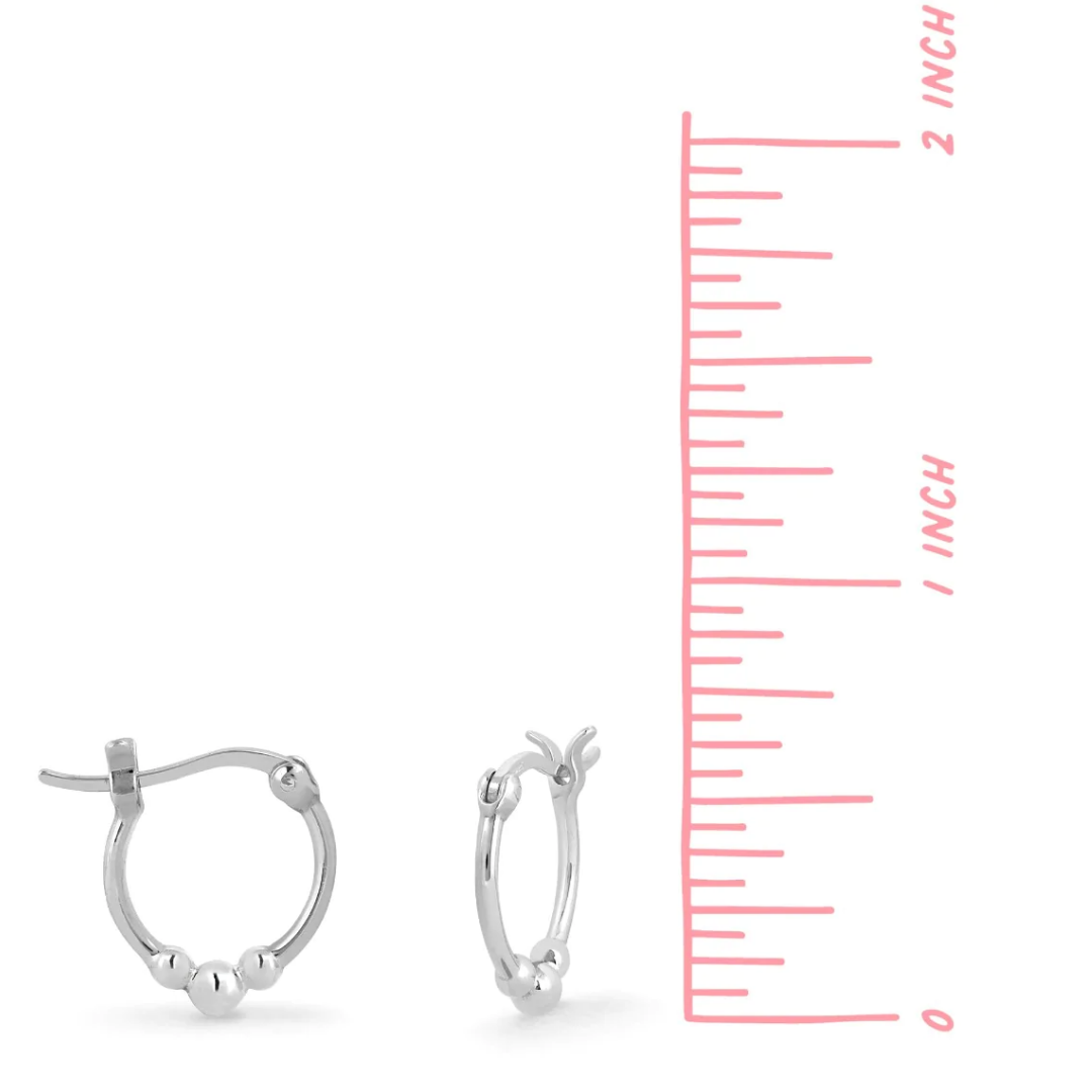 Snap top silver hoop with three small silver balls on the bottom, seen on white background from side and front view next to a pink ruler, measure just under .75 inches. 