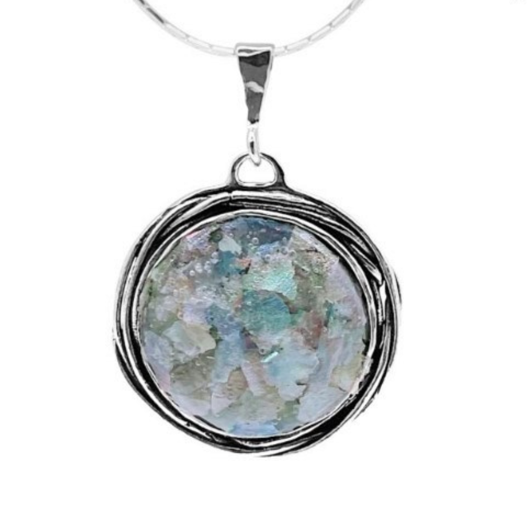 1 inch diameter piece of 2000 year old Roman glass set in an ornate Sterling Silver Bezel. Includes 18 inch chain.