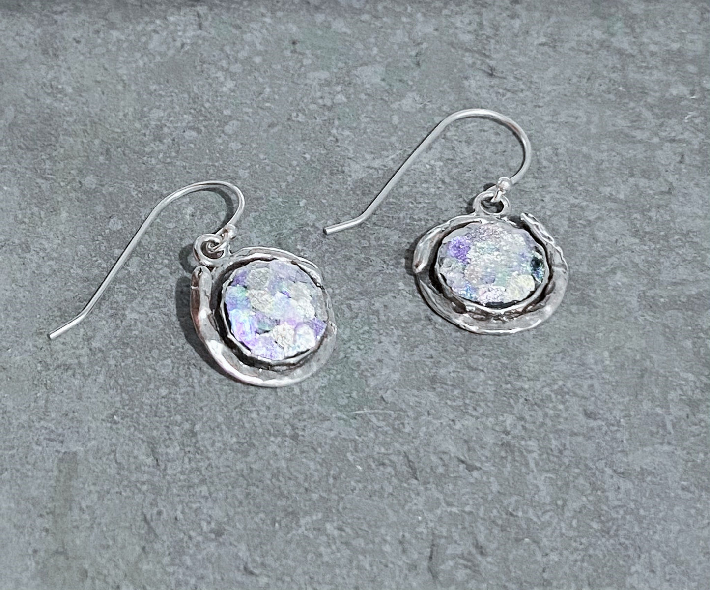 Sterling silver drop earrings with a Roman glass circle as the centerpiece. The glass is 2000 years old. 1.25" long including the wire.