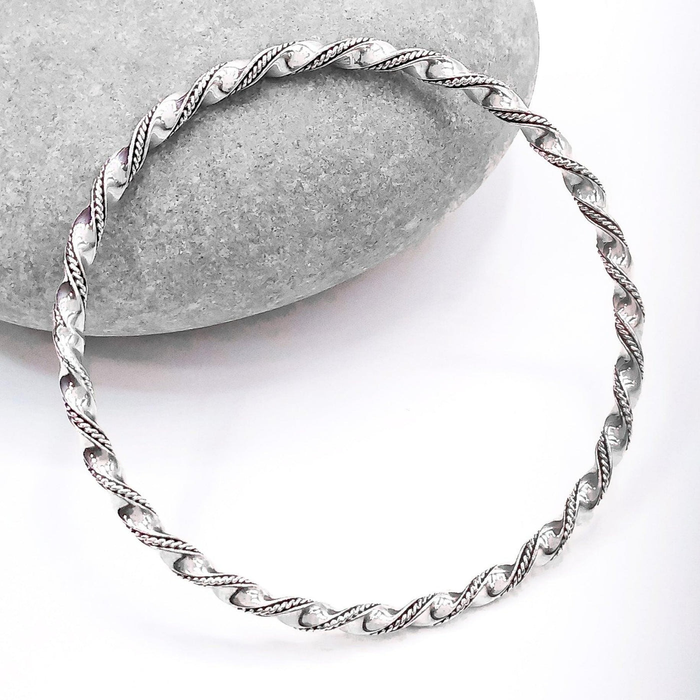 Sterling Silver Wire Twist Bangle - the silver is in a large twist pattern with a small braid pattern running between the twists
