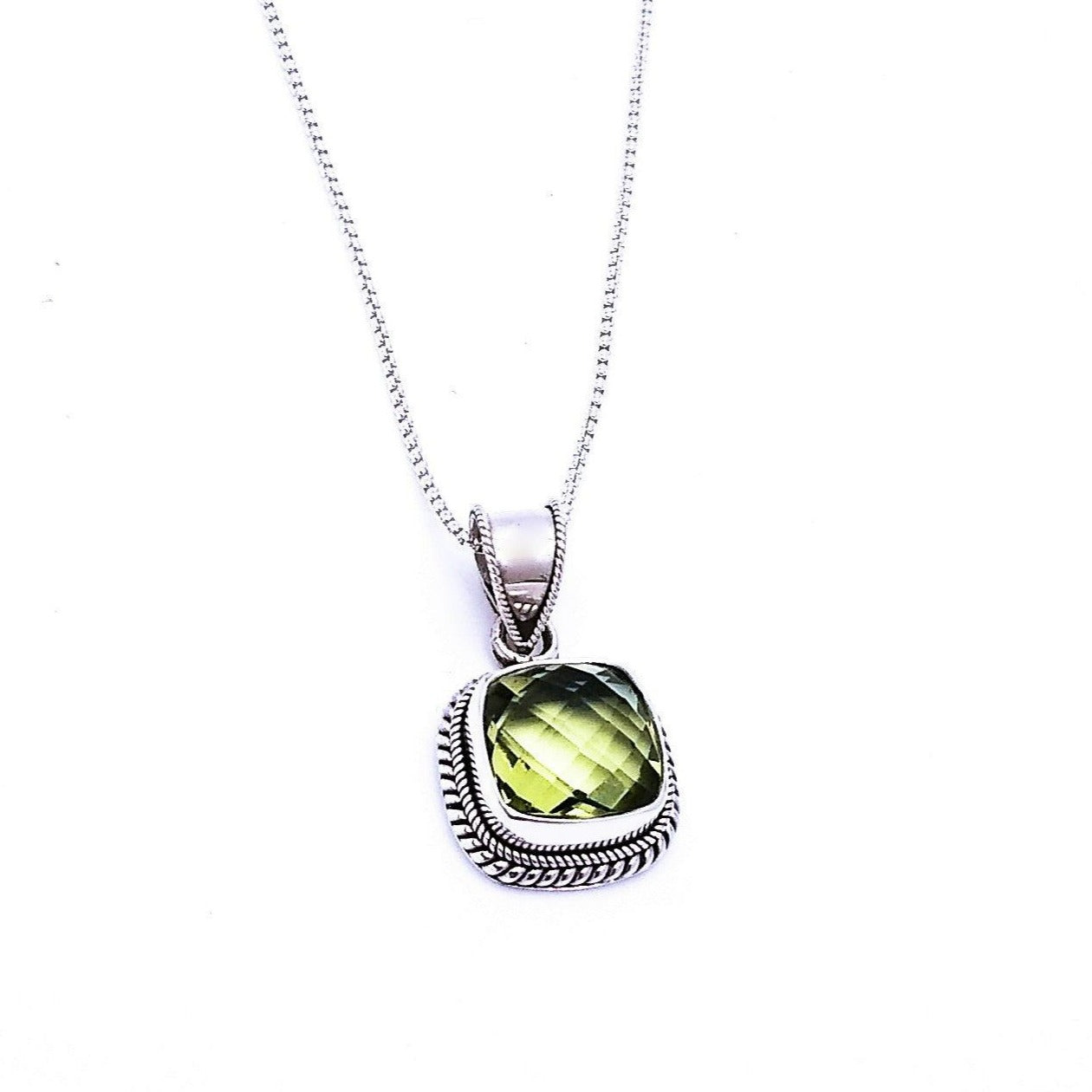 Sterling silver square-shaped pendant with green amethyst in the middle, lined with a woven rope pattern along the sides. Comes on an 18-inch chain.