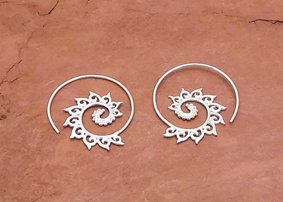 Sterling silver swirl earrings with elevent points stretching out from the center of the swirl.