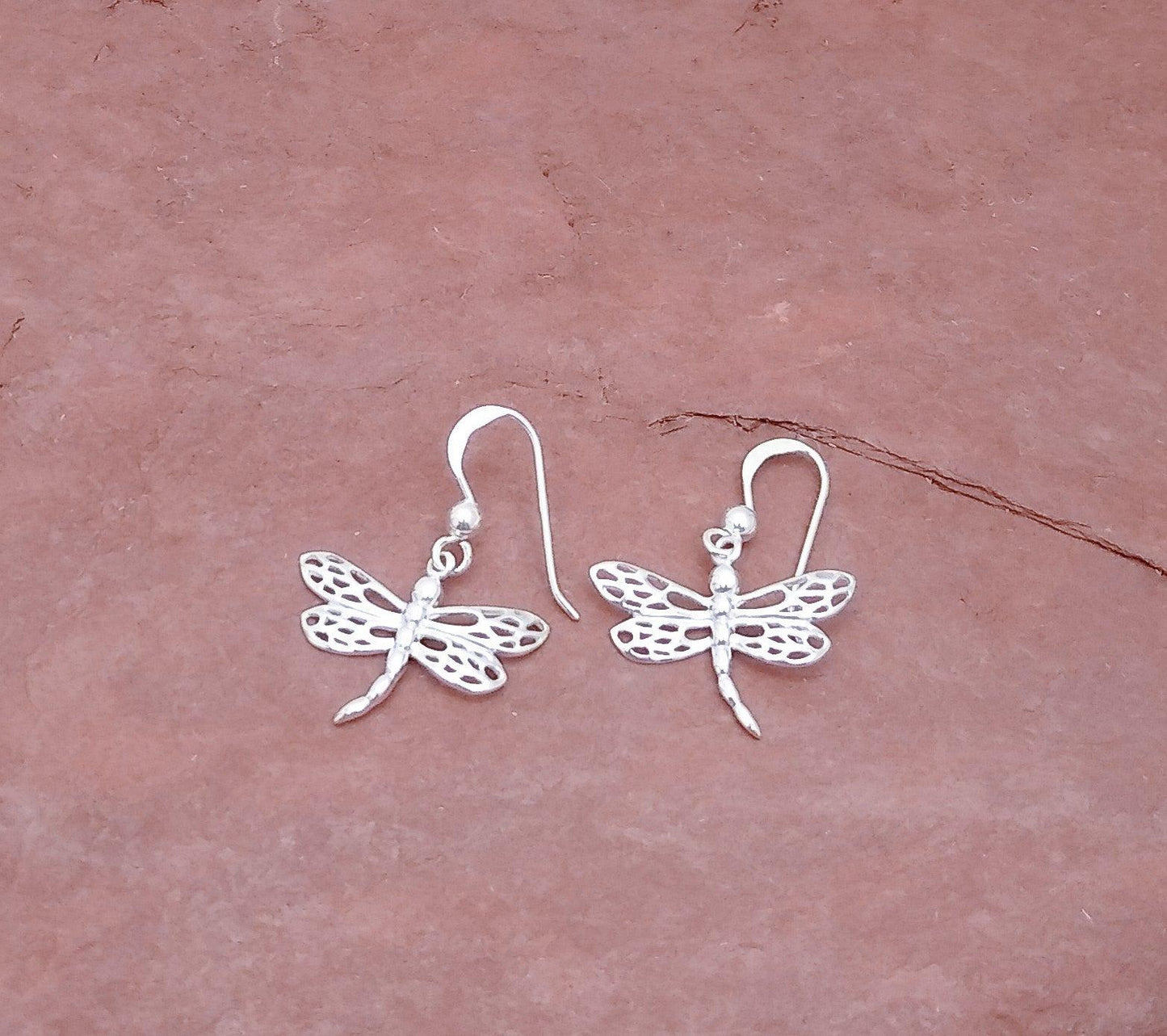 Sterling drop earring of dragonfly with 4 wings with cutout details and straight tail on a French wire