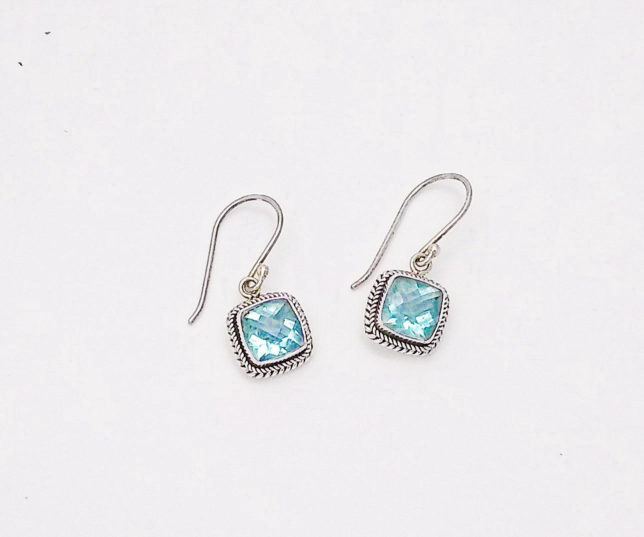 Sterling silver square-shaped earrings with rope border on a French wire. There's a blue topaz stone in the middle, December birthstone