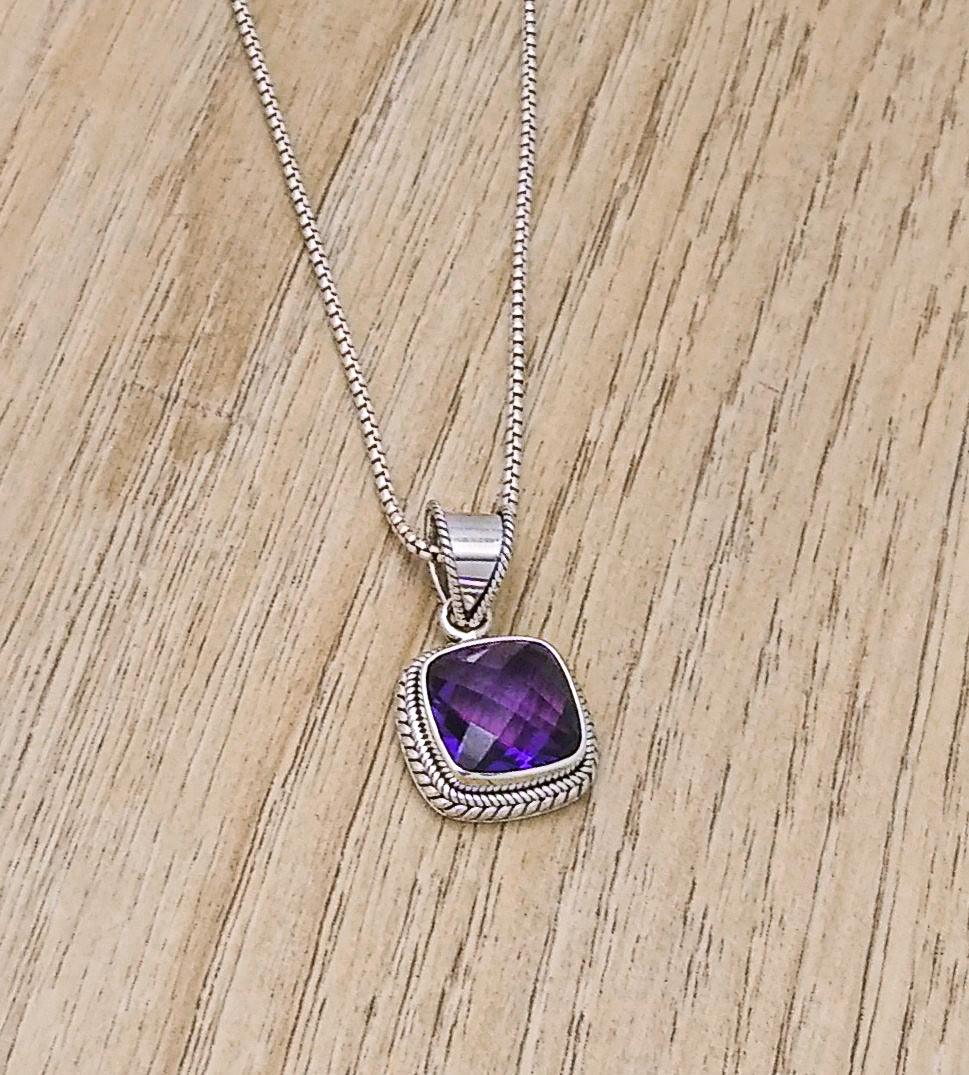 Sterling silver square-shaped amethyst pendant with a woven bali design along the sides. 18-inch chain