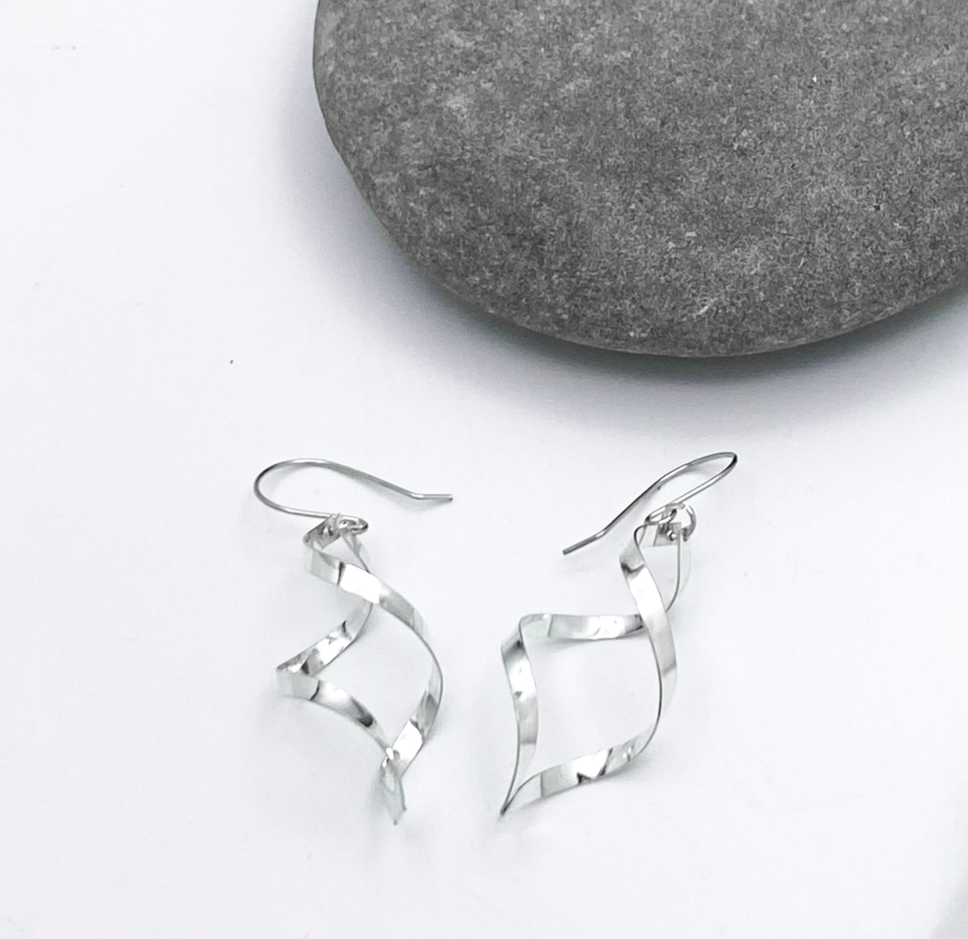 Sterling silver spiral earring. 1 3/4 inches long. Light and beautiful. Made in Taxco, Mexico. Urbansterlingsilver.com