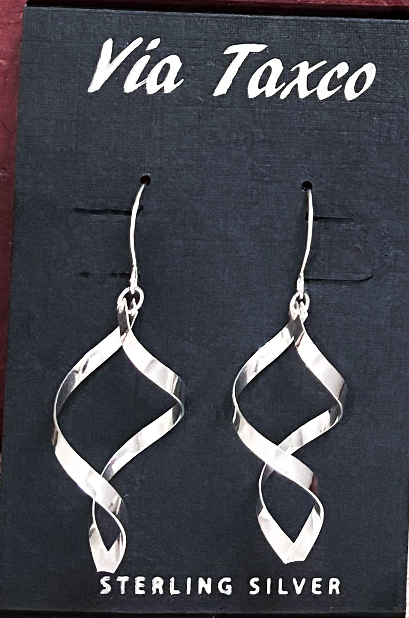 Sterling silver spiral earring. 1 3/4 inches long. Light and beautiful. Made in Taxco, Mexico. Urbansterlingsilver.com
